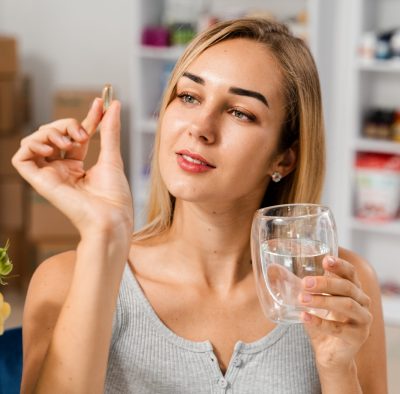 girl holding omega 3 fish oil capsule for bone mai 2026 03 29 01 53 38 utc